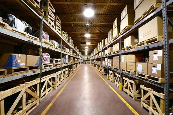 Organized warehouse with boxes on shelves for storage services
