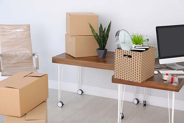 Office items packed in boxes for commercial moving services
